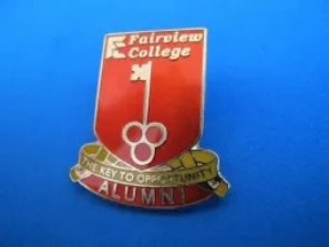 A red and white pin with the words " fairview college alumni ".