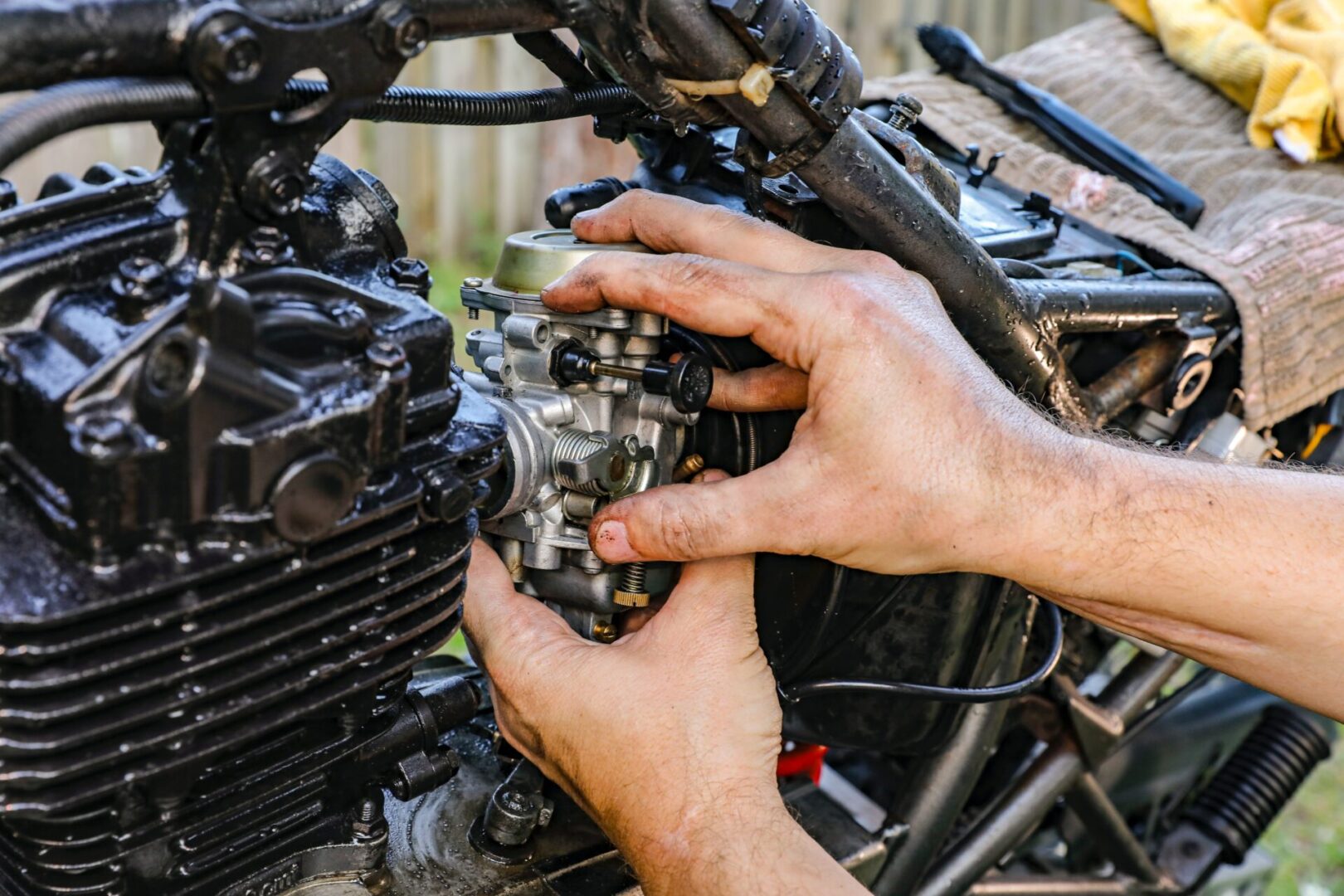 A person working on an engine of a motorcycle.
